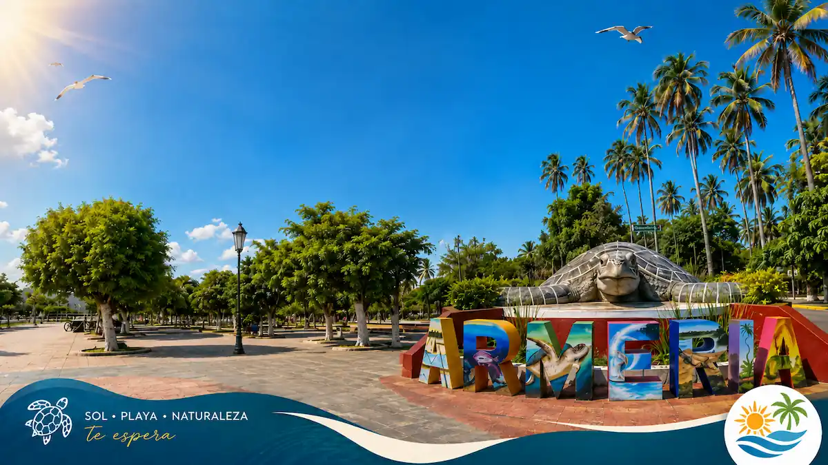 Plaza principal de Armería, Colima, con un monumento de tortuga gigante, letras decorativas coloridas y palmeras bajo un cielo despejado.
